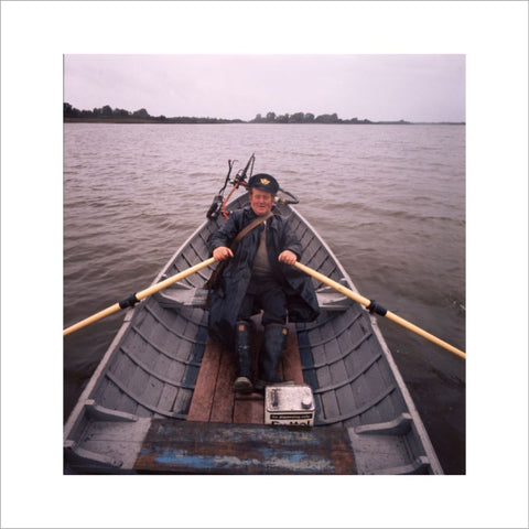 Postman John Rooney rowing across Lough Erne in Ulster