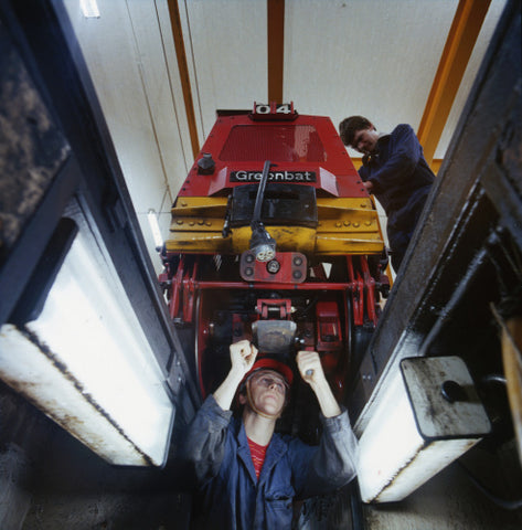 Two engineers work on a locomotive